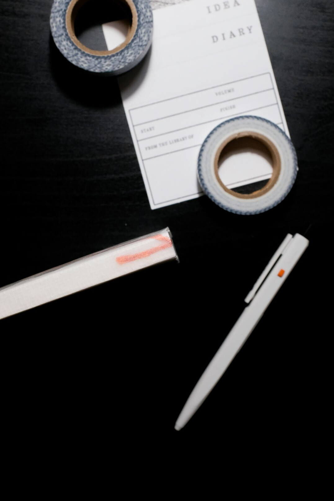 Stack of documents with a pen and highlighter used for verifying claims